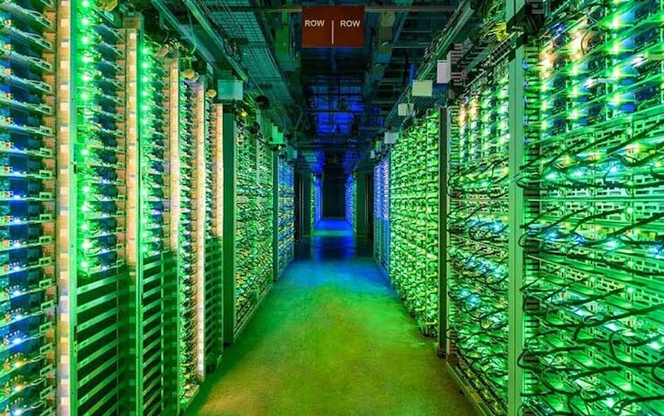 The blinking lights of racks of Google servers glow in a darkened data hall in St. Ghislain, Belgium. (Image: Google)