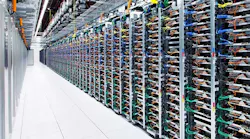 A long row of racks housing servers inside the Google data center in Mayes County, Oklahoma. (Photo: Google)