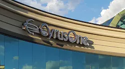 The CyrusOne logo, framed by clouds, on one of the company’s data centers. (Photo: Rich Miller)