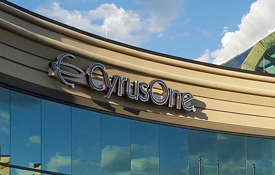 The CyrusOne logo, framed by clouds, on one of the company&rsquo;s data centers. (Photo: Rich Miller)