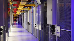 The distinctive blue-lit, cage-lined corridors inside an Equinix data center. (Photo: Equinx)