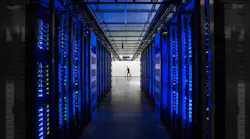 Rows of blue-lit server cabinets inside one of Facebook’s data centers in Altoona, Iowa. (Photo: Facebook)