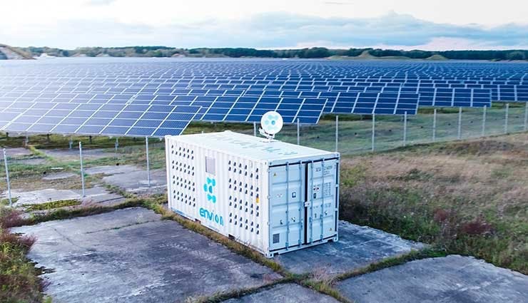 A cryptocurrency mining module next to a solar power array. (source: BusinessWire)