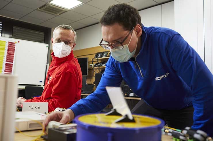 Nokia engineers working at a 100FGbps PON (passive optical network) testing lab. (Image: Nokia)