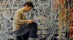 Technician in front of a manual patch panel. (Photo: Telescent)