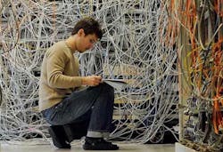 Technician in front of a manual patch panel. (Photo: Telescent)