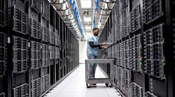 A technician works in rows of server racks in a Microsoft Azure cloud data center. (Image: Microsoft)