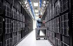 A technician works in rows of server racks in a Microsoft Azure cloud data center. (Image: Microsoft) A technician works in rows of server racks in a Microsoft Azure cloud data center. (Image: Microsoft)