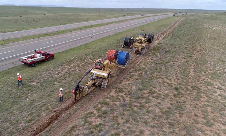 A team of engineers laying long-haul dark fiber in a trench for a Facebook network deployment. (Photo: Facebook)