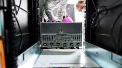 A powerful new NVIDIA DGX A100 system being installed in a rack at Argonne National Laboratory. (Image: NVIDIA)