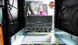 A powerful new NVIDIA DGX A100 system being installed in a rack at Argonne National Laboratory. (Image: NVIDIA)