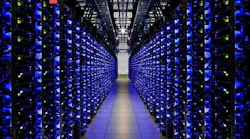 A blue-lit row of servers in a Google data center, (Photo: Google)