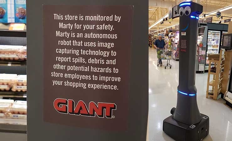 Marty (at right) is a robot that patrols the aisles of Giant Food Stores, using AI and computer vision to detect and report spills. (Photo: Rich Miller)