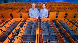 Dr. Matthew Lamont (left), DownUnder GeoSolutions (DUG) managing director, and Phil Schwan, DUG CTO, stand among the cooling tanks that make up the “Bubba” supercomputer at the Houston Skybox data center. (Credit: DownUnder GeoSolutions)