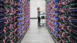 A row of racks filled with Google’s AI hardware, known as TPUs. (Photo: Google)
