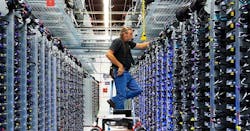 Google&rsquo;s Roger Harris performs maintenance on equipment in one of the company&rsquo;s data centers. (Photo: Google)