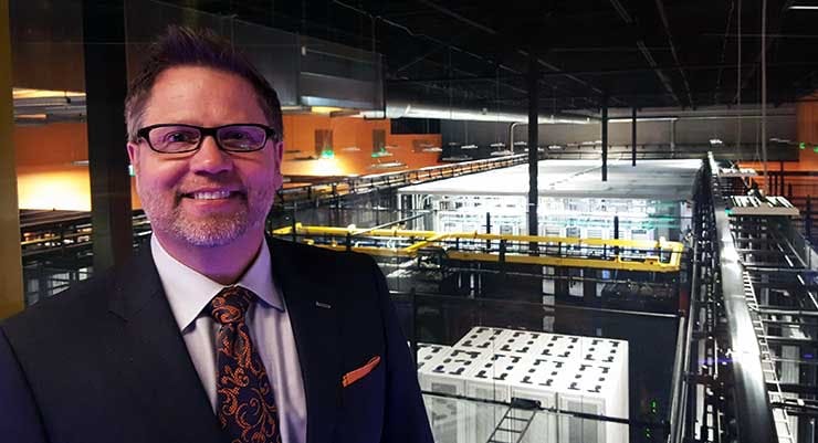RagingWire CEO Douglas Adams on the catwalk corridor overlooking the data hall in the company&rsquo;s CA3 data center in Sacramento. (Photo: Rich Miller)