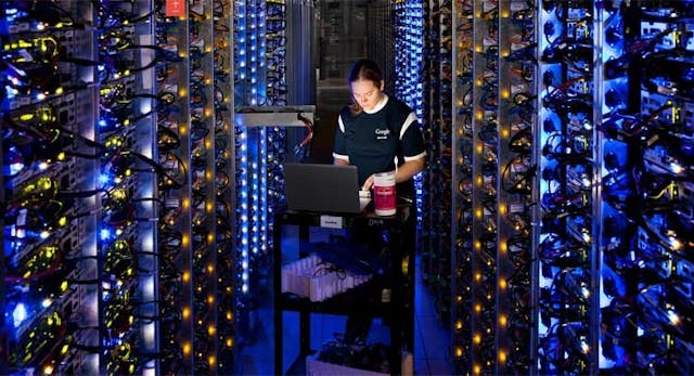 Google&rsquo;s Denise Harwood replaces a CPU amid the blue-lit server-packed racks in the company&rsquo;s data center in The Dalles, Oregon. (Photo: Google)
