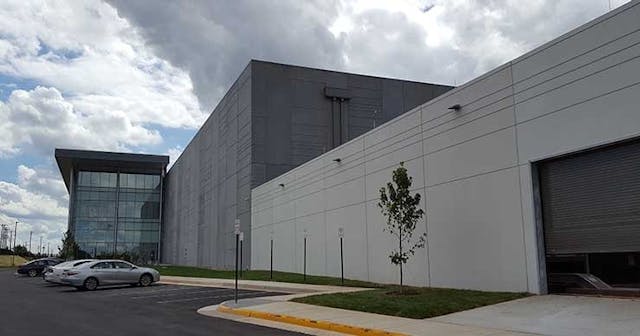 The front facade of Sterling V, showing the glass exterior on the three-story Class A office space. (Photo: Rich Miller)