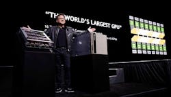 NVIDIA founder and CEO Jensen Huang shows off new hardware for the DGX-2, the upgraded version of the company&rsquo;s desktop supercomputer. (Photo: NVIDIA Corp.)