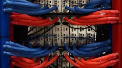 The rear view of a rack of servers using the LiquidCool immersion system. Blue lines bring dielectric coolant to the server to cool components, while the red lines return the fluid to a heat exchanger. (Photo: LiquidCool Solutions)