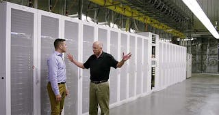 Microsoft&rsquo;s Christian Belady (right) among the server aisles of the company&rsquo;s newest data center in Quincy, Washington with Microsoft&rsquo;s Alex Bradley, Visible behind Belady is a fan wall, one of the new wrinkles in the Generation 5 data center design. (Image: Microsoft)