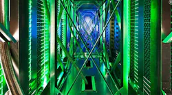 Inside the hot aisle of a Google data center, hundreds of fans funnel hot air from the server racks into a cooling unit to be recirculated. The green lights are the server status LEDs reflecting from the front of the servers. (Photo: Google)