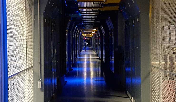 A corridor between the colocation cages inside the Equinix SV5 data center in San Jose, California. (Photo: Rich Miller)