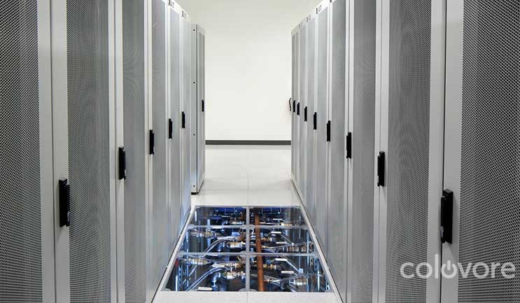The data hall at Colovore in Santa Clara, with a clear tile displaying the water pipes beneath the raised floor. (Photo: Colovore)