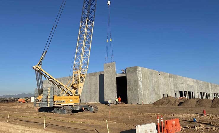 A pre-fabricated concrete section being hoisted into place during the construction of a Compass Datacenters campus. (Photo: Compass Datacenters)