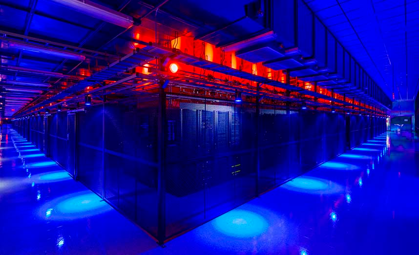 A vast data hall filled with racks of servers inside caged enclosures at the Switch campus in Las Vegas.
