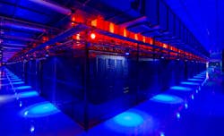 A vast data hall filled with racks of servers inside caged enclosures at the Switch campus in Las Vegas.