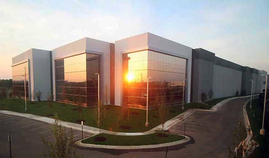 The morning sun reflects off the facade of Building P, a large Digital Realty data center in Ashburn, Virginia.