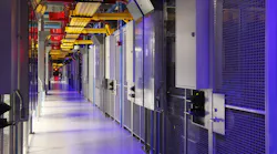 A corridor of cages housing colocation equipment inside an Equinix data center.