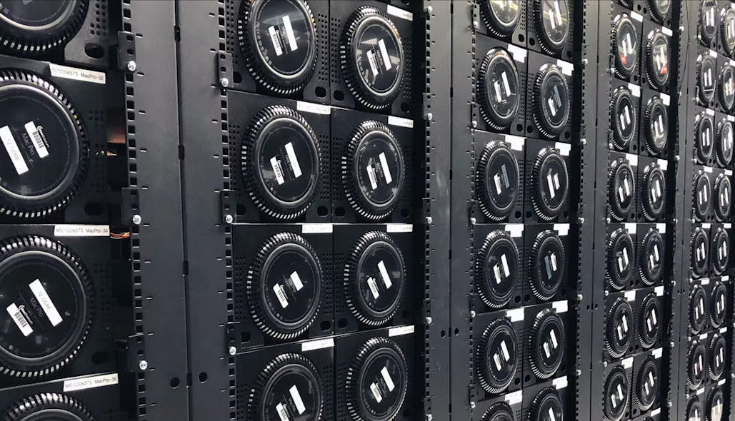 A row of Mac Pro computers housed in custom racks in a Mac Stadium data center.