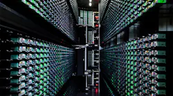 An early example of data center automation is this tape library in a Google data center in South Carolina, where robotic arms (visible at the end of the aisle) load and unload tapes.