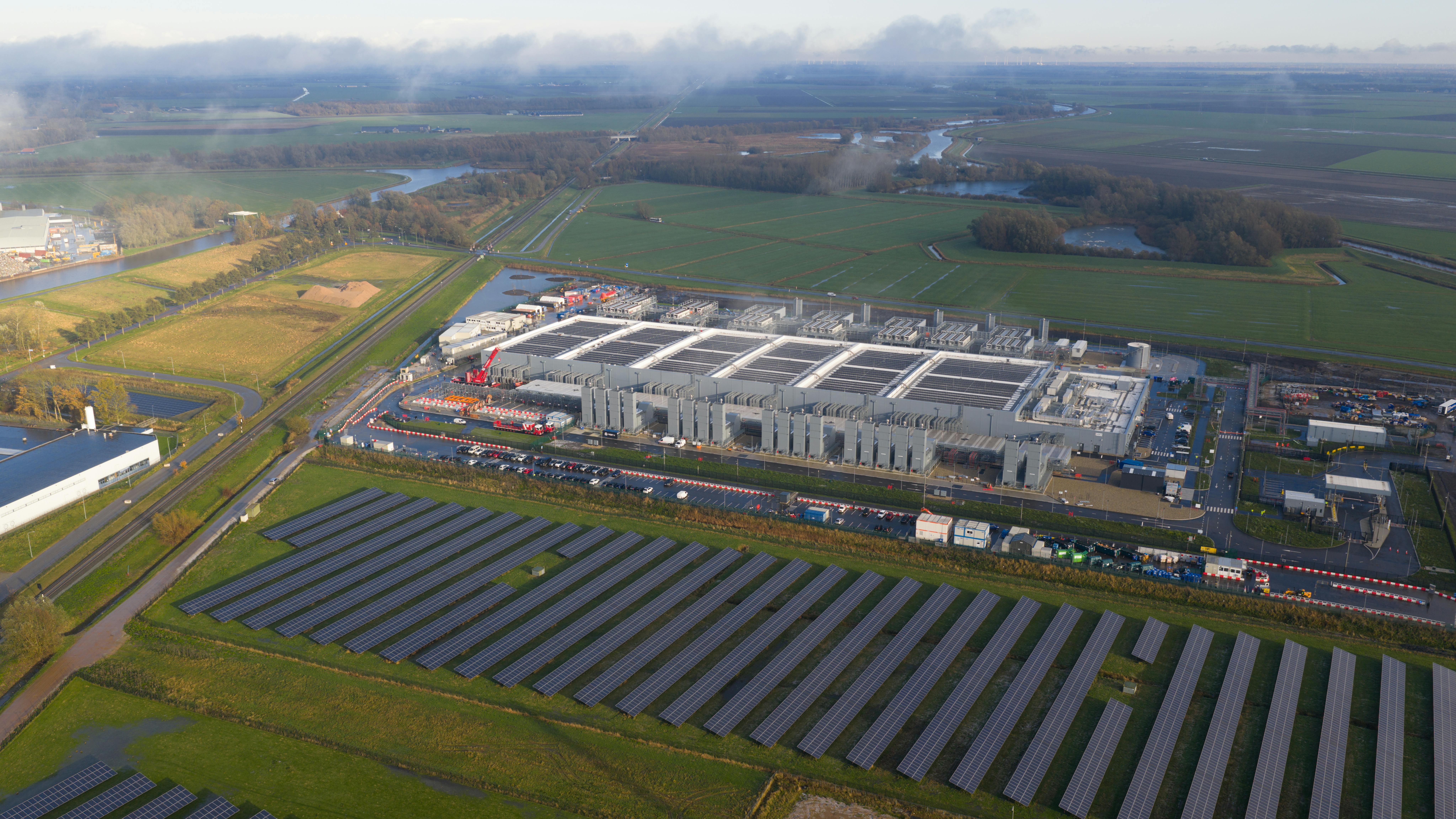 Aerial drone close-up of a newly built hyperscale data center in Winschoten, Netherlands, designed to support advanced AI workloads while operating on a mix of sustainable and renewable energy resources.