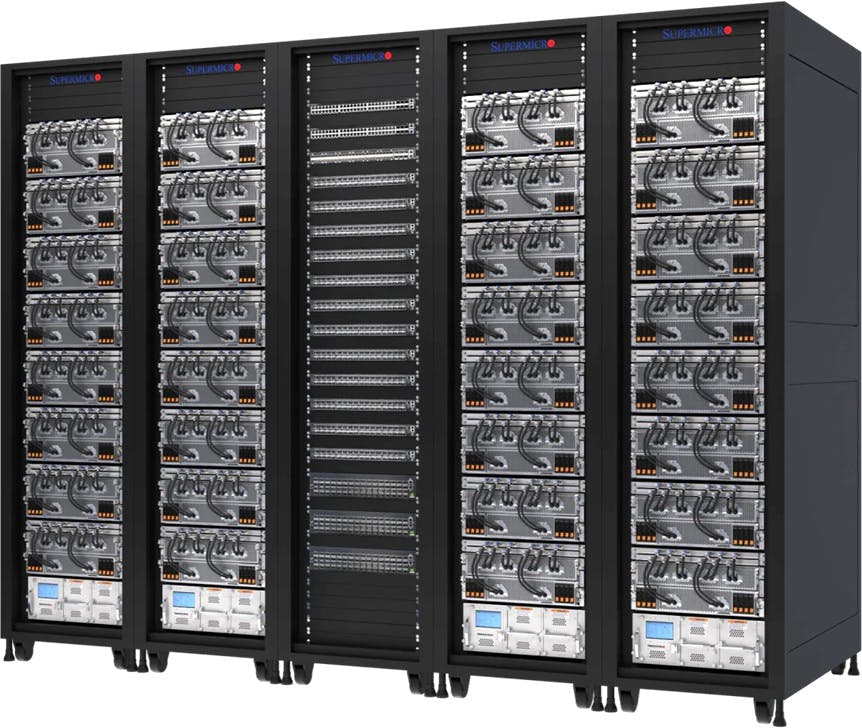 Supermicro&rsquo;s liquid-cooled AI cluster at xAI&rsquo;s Colossus facility, showing 32 NVIDIA HGX H100/H200 8-GPU, 4U systems&mdash;256 GPUs total&mdash;deployed across five high-density racks.