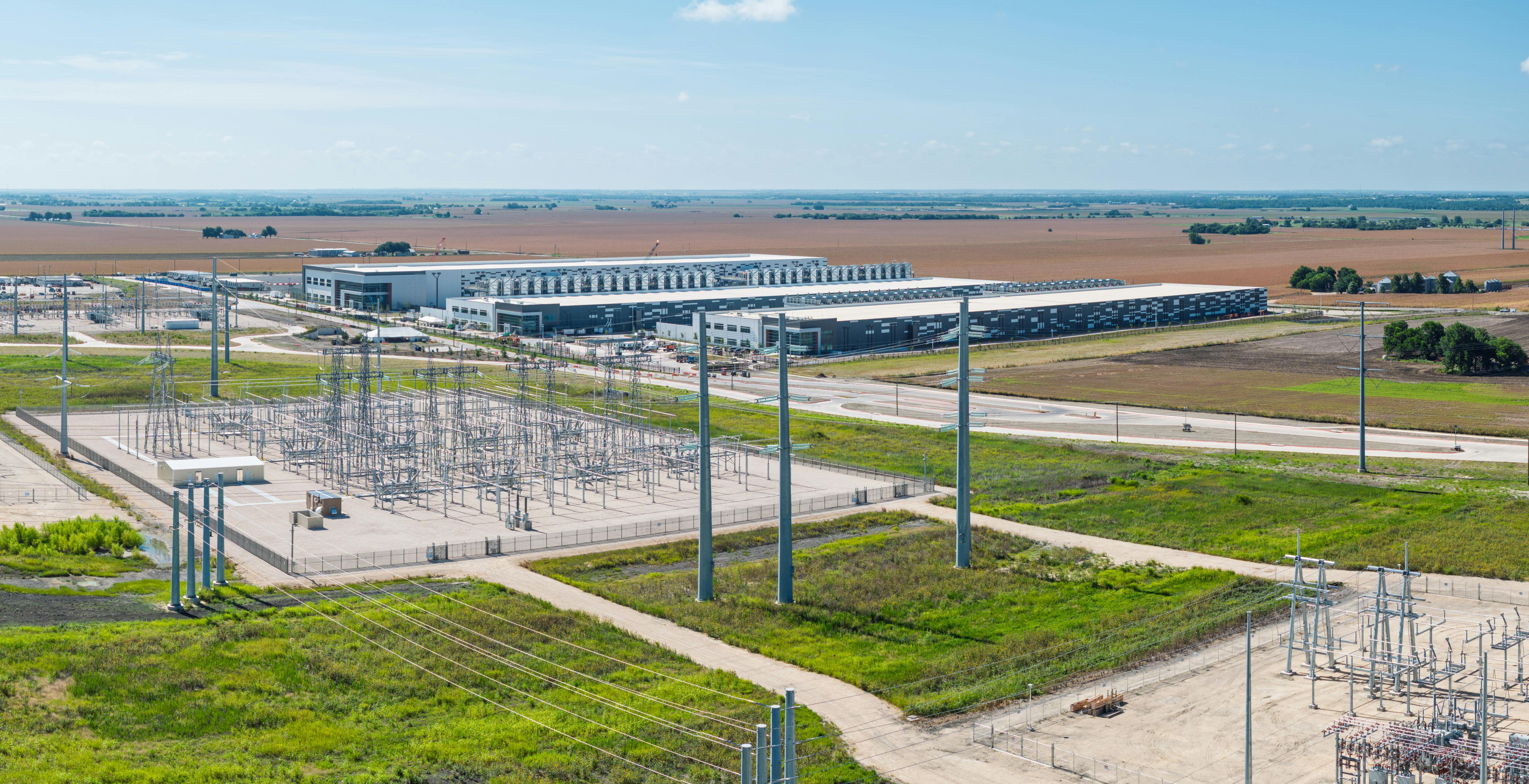 Electrical power grid substation feeding 600 MW to new AI data center campus construction in Hutto, Texas.