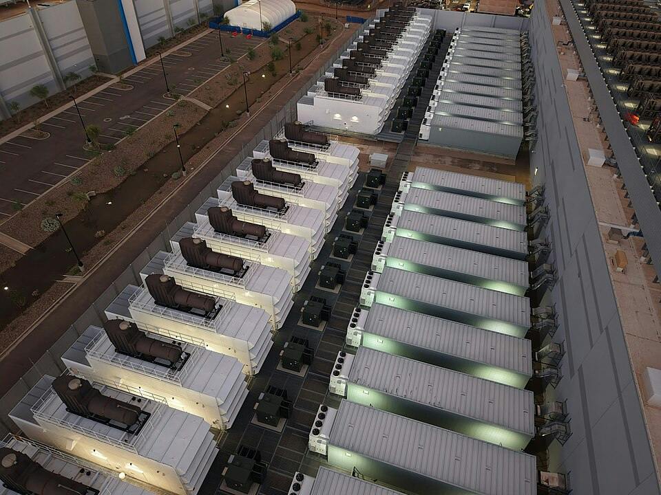Backup generators at a Mesa, Arizona data center underscore the physical infrastructure behind time-to-power, where faster deployment still depends on reliable electrical systems, rigorous testing and successful commissioning before capacity can come online.